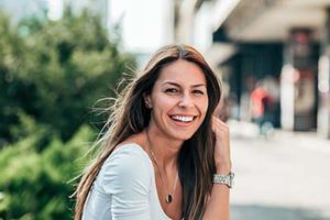 A woman smiles as she thinks about general dentistry in Kohrville, TX