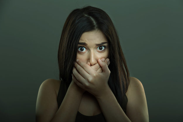 causes of bad breath (1) woman suffering from dental anxiety