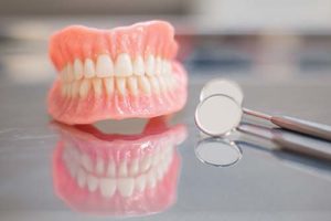 pair of full dentures on a dentist table