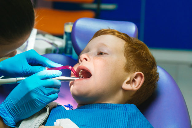 treating a chipped tooth a dentist works on treating a child's chipped tooth