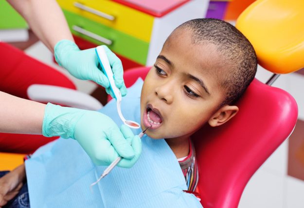 pediatric dental emergency a dentist helps a child through a pediatric dental emergency