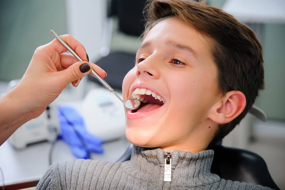 young man gets fluoride treatment