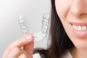 woman shows off her clear aligner trays 