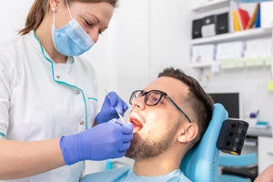 man receives restorative dentistry treatment 