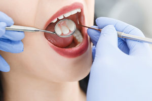 woman receives a dental exam