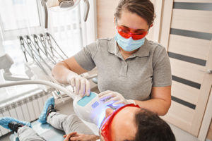 dentist providing teeth whitening services