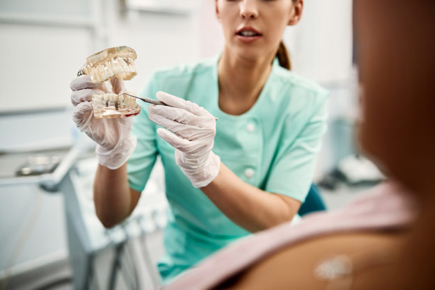 4 Benefits of Dental Implants a woman explains the benefit of dental implant